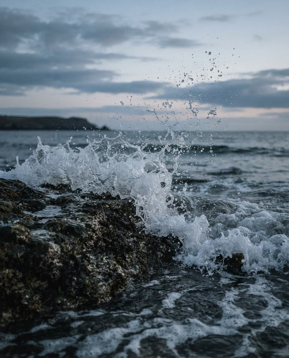 A wave breaking on coastal rocks